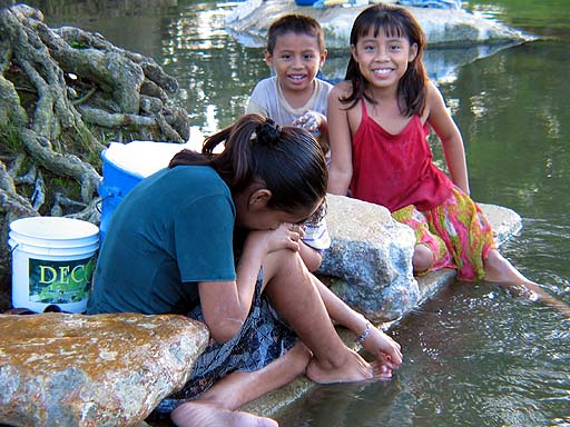 Friendly local children bathing and doing laundry in the Caya river.jpg