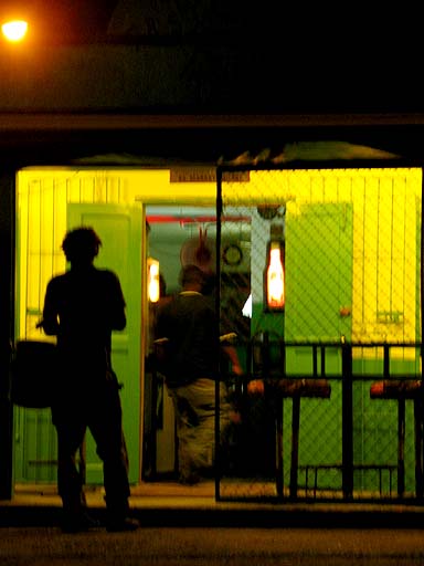 Silhouette of a man hanging out in front of a bar .jpg