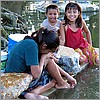 Friendly local children bathing and doing laundry in the Caya river.jpg