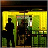 Silhouette of a man hanging out in front of a bar .jpg