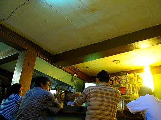 Locals talking about the football game drinking Belican beer, the beer of Belize .jpg