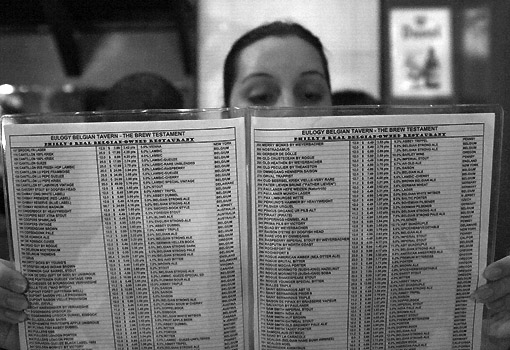 Megan inspects the beer menu at the Eulogy Belgian Beer Bar